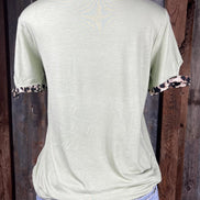 Celeste Clothing brand. Light sage green top with leopard trim cut out detail on neck and sleeves. S, M, L, XL. $15