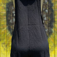 Black romper by Shiying Fashion displayed on a hanger with a close-up view of the fabric and design details.