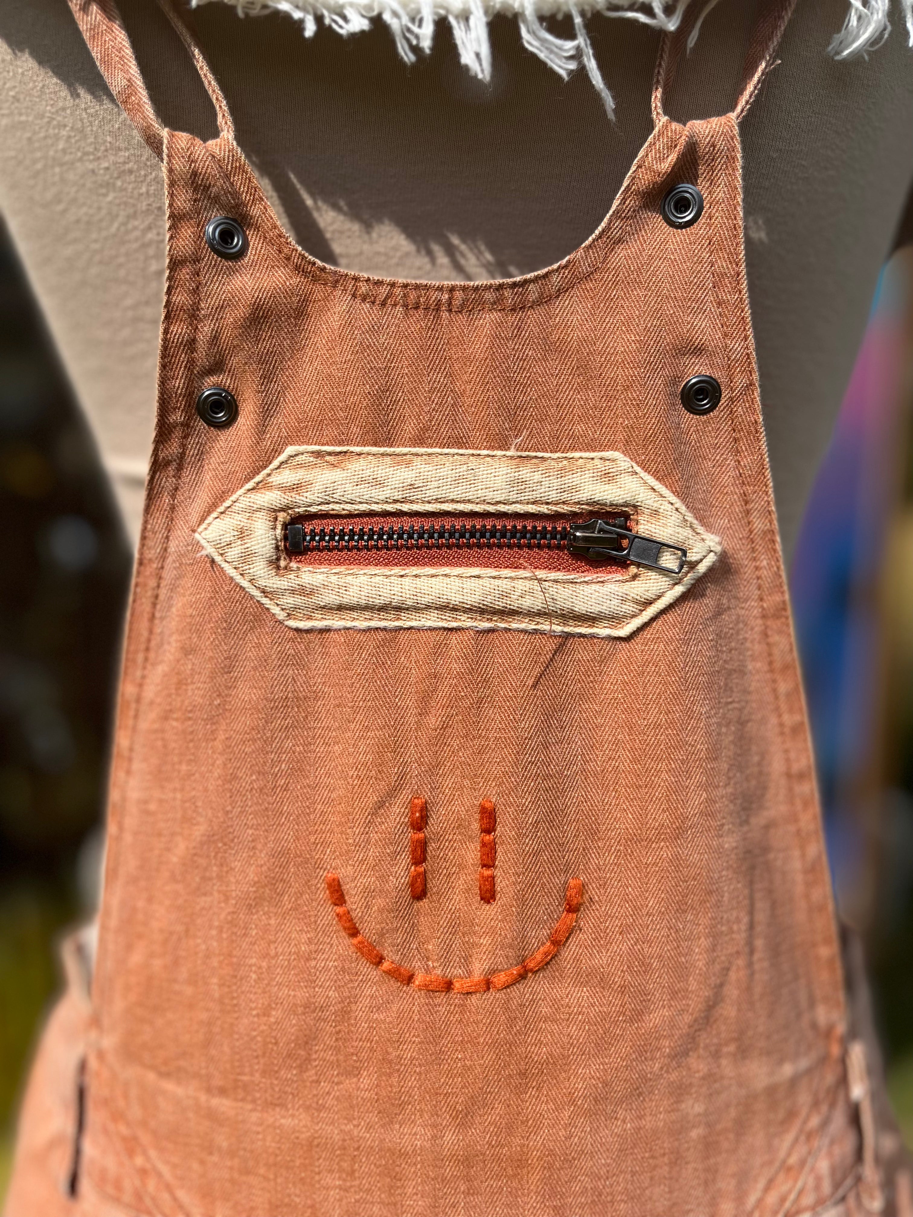 Washed cargo romper by Oli&Hali featuring a relaxed fit, multiple pockets, and casual style in soft, durable fabric.