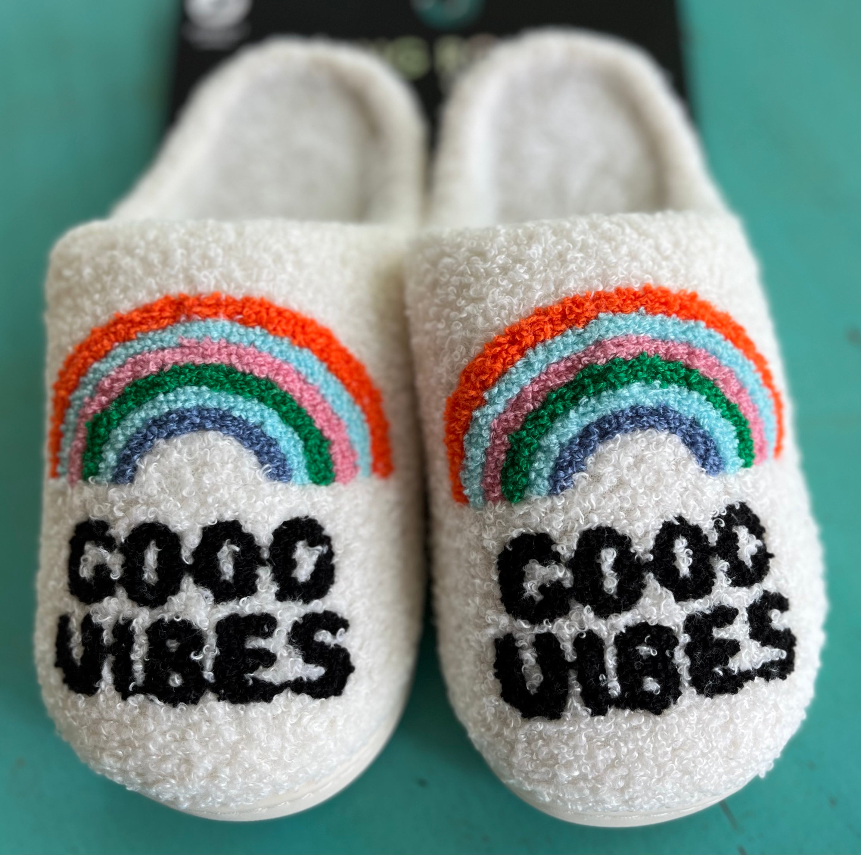 Living Royal Good Vibes slippers with colorful rainbow design, soft fabric, and cozy slip-on style for comfortable indoor wear.
