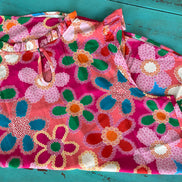 Pink floral blouse by Shiying Fashion featuring a lightweight fabric and delicate flower print, displayed on a hanger.