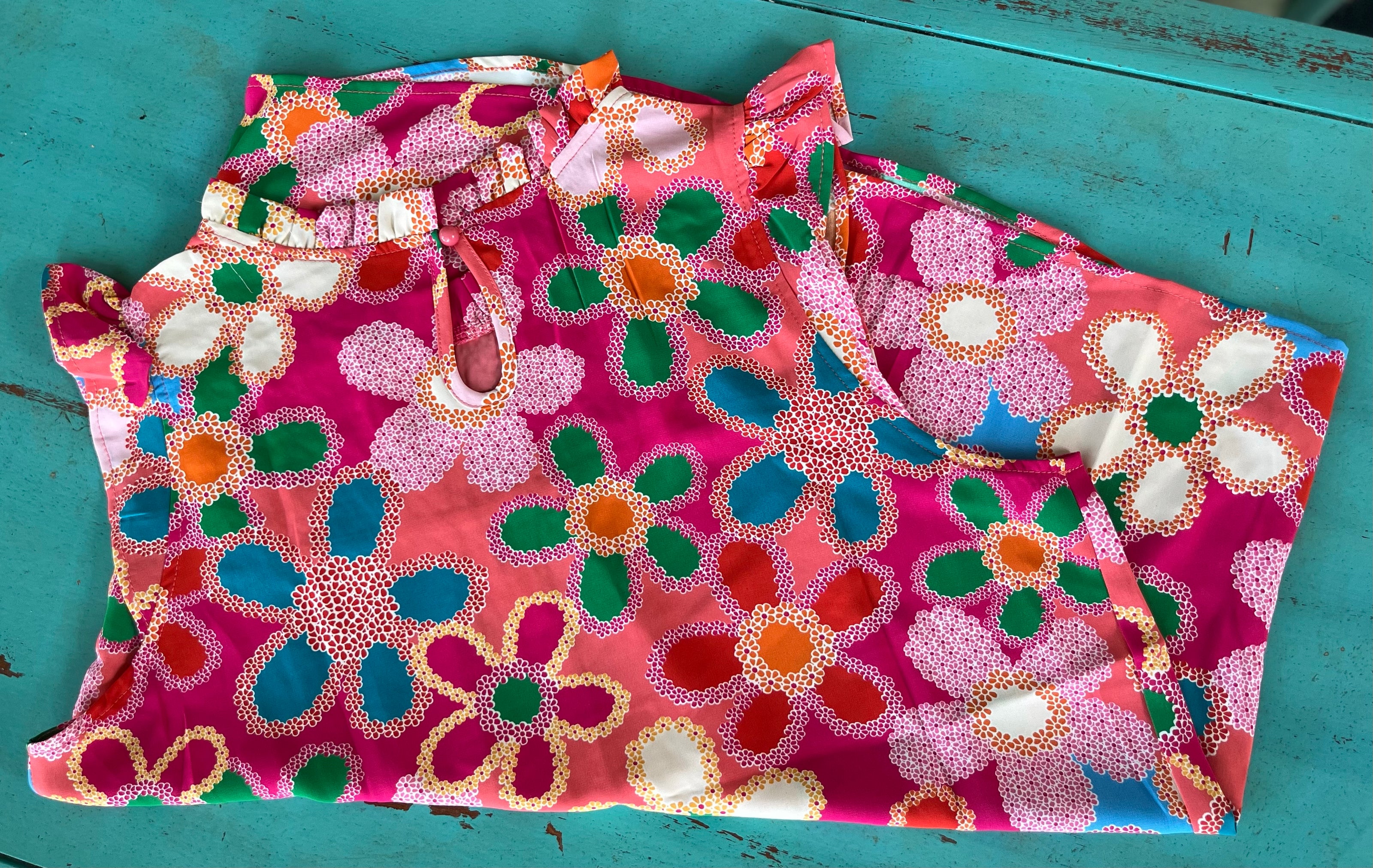Pink floral blouse by Shiying Fashion featuring a lightweight fabric and delicate flower print, displayed on a hanger.