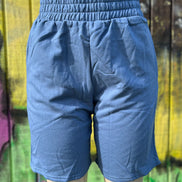 Vintage blue shorts by Vanilla Monkey, casual denim style with front pockets and rolled hem, displayed on a neutral background.