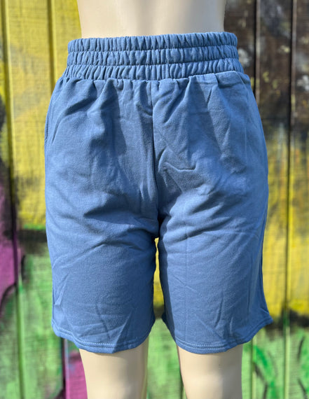Vintage blue shorts by Vanilla Monkey, casual denim style with front pockets and rolled hem, displayed on a neutral background.
