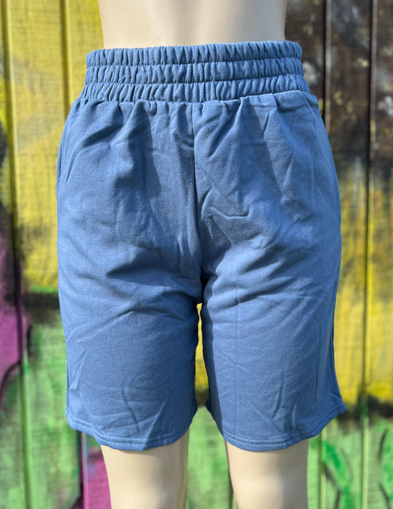 Vintage blue shorts by Vanilla Monkey, casual denim style with front pockets and rolled hem, displayed on a neutral background.