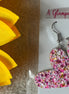 A Glamper's Creation, LLC brand. Silver dangle heart earrings with hot pink, light pink, gold and white glitter. $10