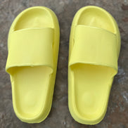 Yellow rubber platform slides by Shop Lev, featuring a chunky sole and open-toe design for casual summer wear.
