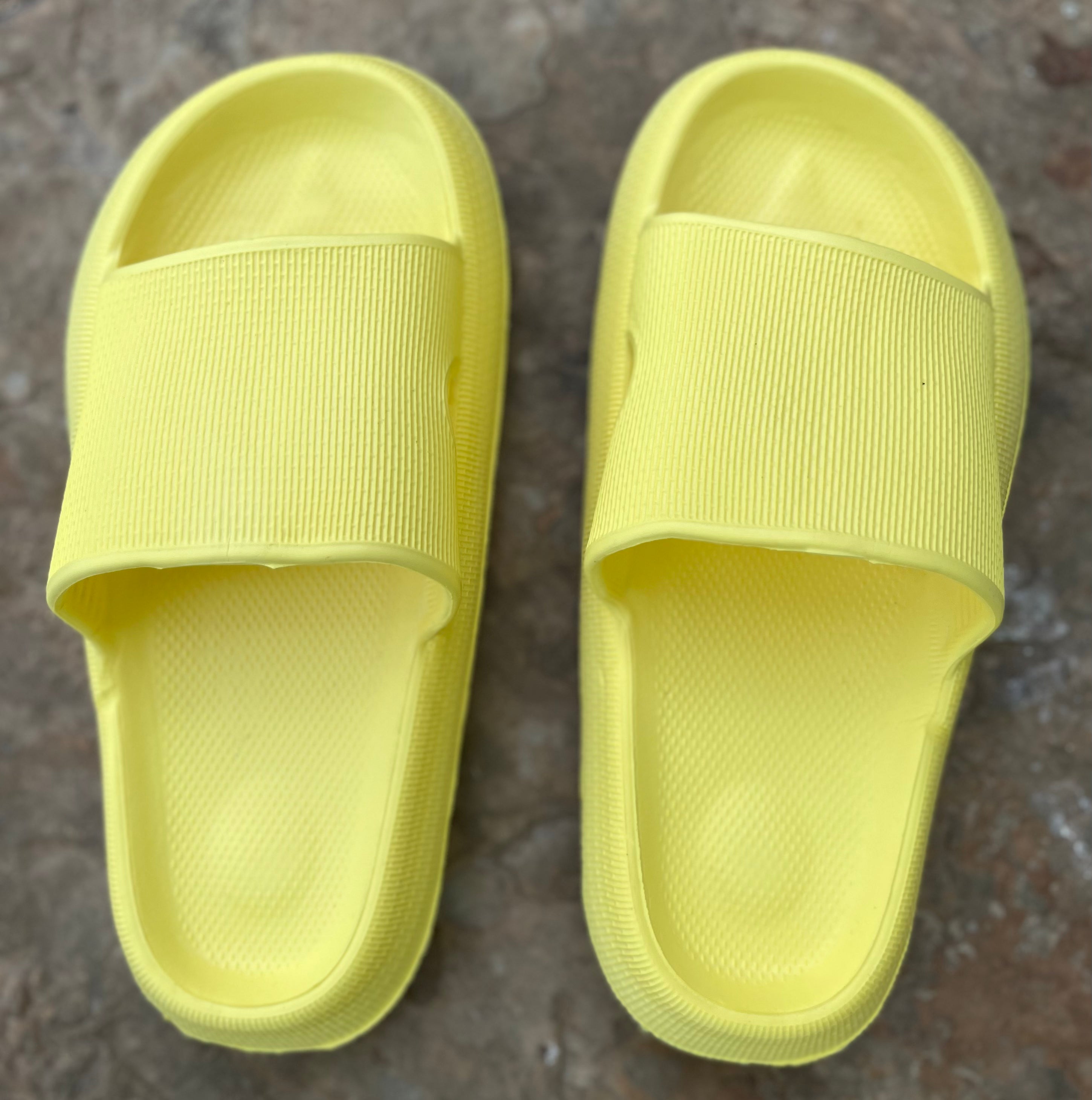 Yellow rubber platform slides by Shop Lev, featuring a chunky sole and open-toe design for casual summer wear.