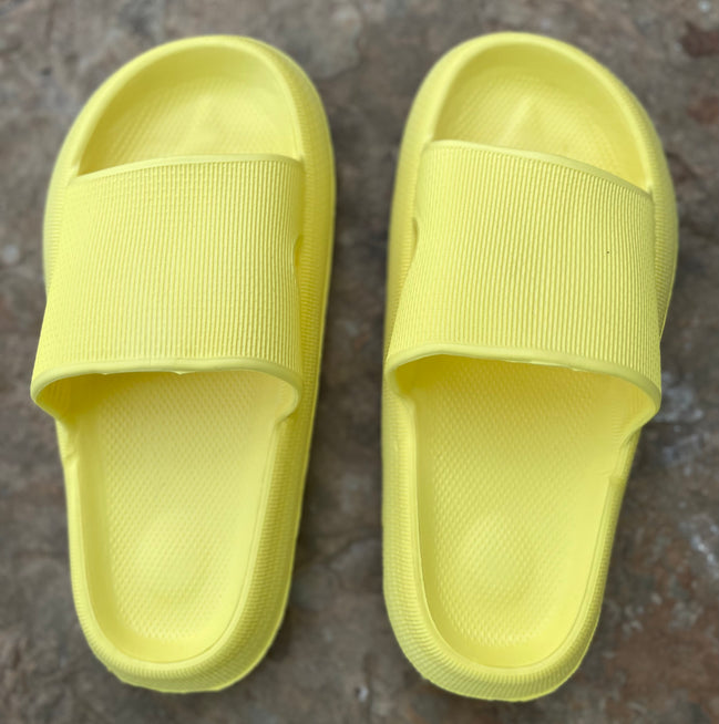 Yellow rubber platform slides by Shop Lev, featuring a chunky sole and open-toe design for casual summer wear.