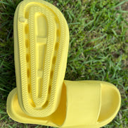 Yellow rubber platform slides from Shop Lev featuring a chunky sole and open-toe design for casual summer wear.