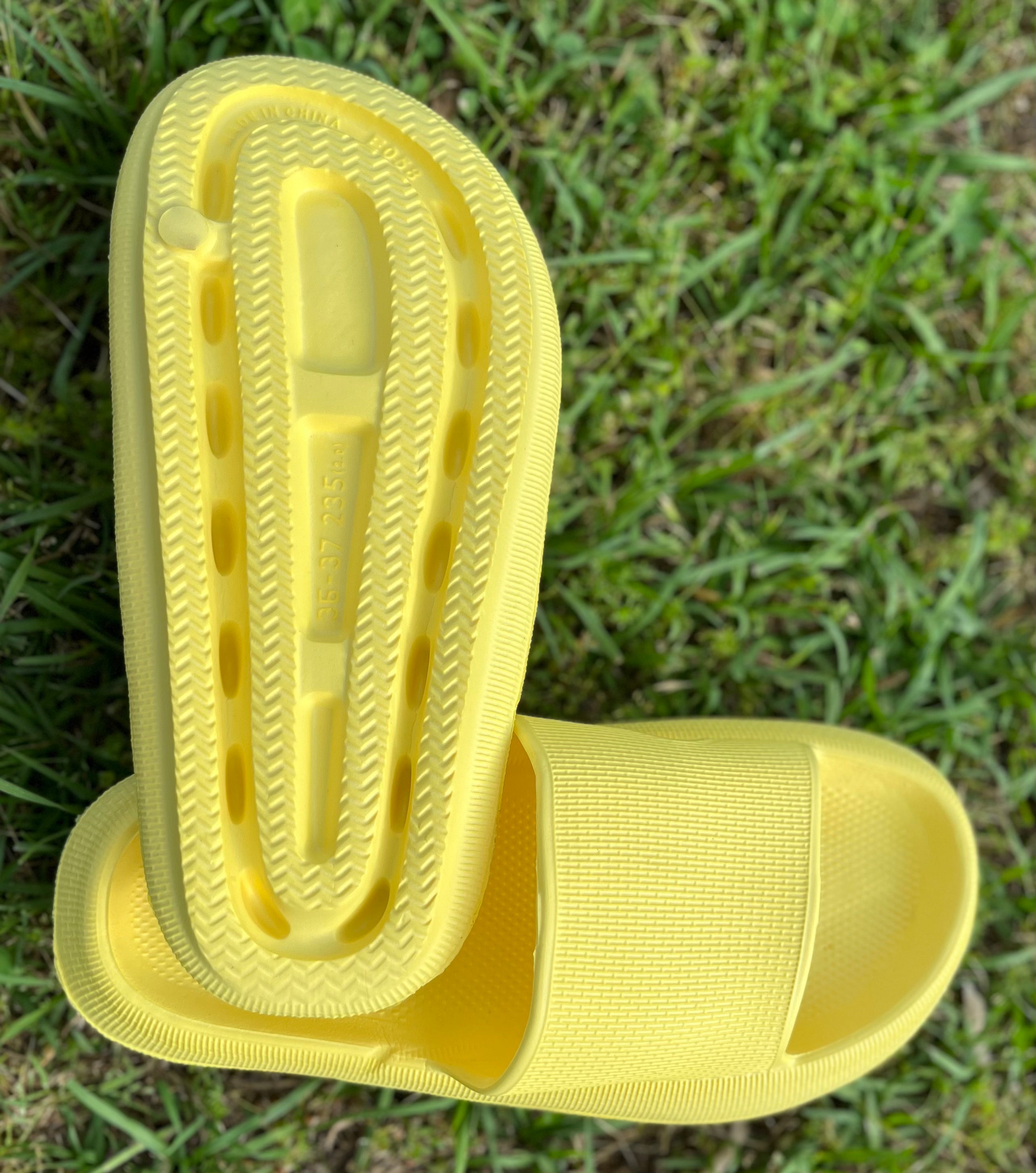 Yellow rubber platform slides from Shop Lev featuring a chunky sole and open-toe design for casual summer wear.
