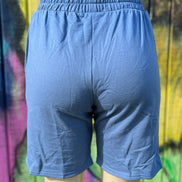 Vintage blue shorts from Vanilla Monkey with a relaxed fit, featuring a waistband and casual style, shown on a hanger.