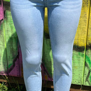 VERVET mid-rise skinny jeans in classic blue denim, featuring a close-up of fitted waist and tapered leg design.