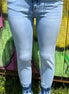 VERVET mid-rise skinny jeans in classic blue denim, featuring a close-up of fitted waist and tapered leg design.
