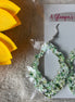 A Glamper's Creations, LLC brand. These scalloped leather earrings are accented in green, white and gold glitter. $10