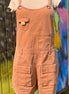 Washed cargo romper by Oli&Hali featuring a relaxed fit, multiple pockets, and casual style, displayed on a hanger.