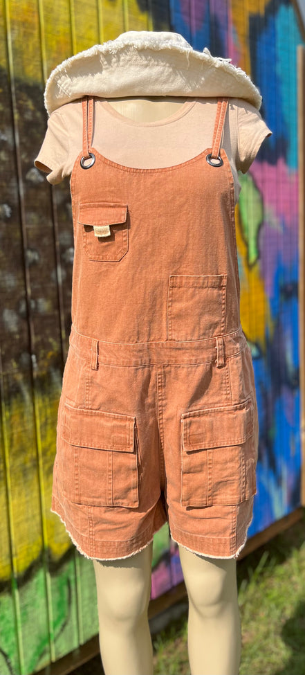 Washed cargo romper by Oli&Hali featuring a relaxed fit, multiple pockets, and casual style, displayed on a hanger.