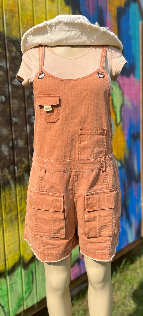 Washed cargo romper by Oli&Hali featuring a relaxed fit, multiple pockets, and casual style, displayed on a hanger.