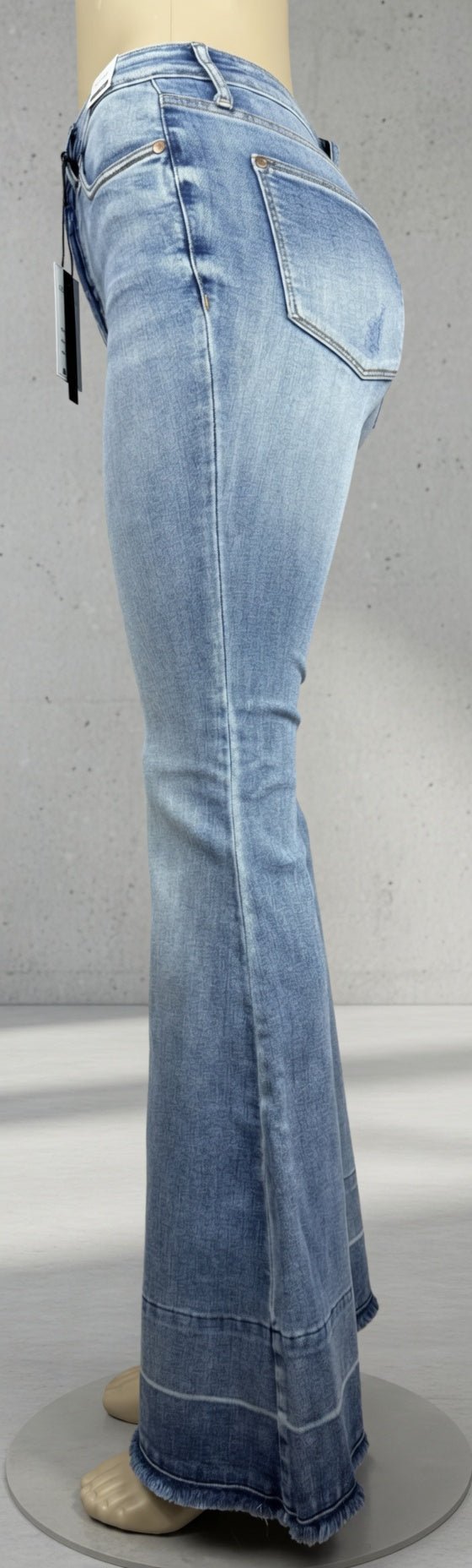 Judy Blue Flares featuring a high-waisted fit, classic denim wash, and flared leg style on a model showcasing casual denim fashion.