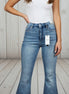 Light blue Judy Blue flare jeans with distressed details and high-waisted fit, styled with a casual top and sneakers.