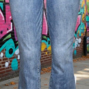 Judy Blue mid-rise release hem cropped bootcut jeans displayed on a model, showcasing the stylish cut and fit.
