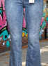 Judy Blue mid-rise release hem cropped bootcut jeans displayed on a model, showcasing the stylish cut and fit.