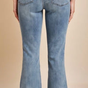 Judy Blue mid-rise release hem cropped bootcut jeans showcasing the stylish fit and distressed details.
