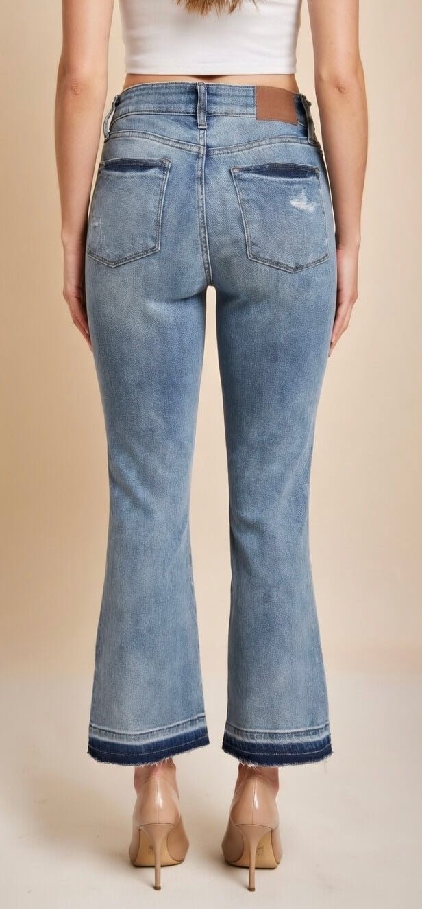 Judy Blue mid-rise release hem cropped bootcut jeans showcasing the stylish fit and distressed details.