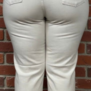 Judy Blue Ecru Plus Jeans showcasing high-waisted fit and classic denim texture in a light beige color.