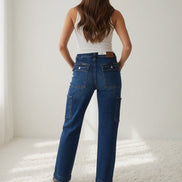 Pair of Judy Blue cargo jeans featuring multiple pockets, relaxed fit, and classic denim wash, showcasing casual streetwear style.