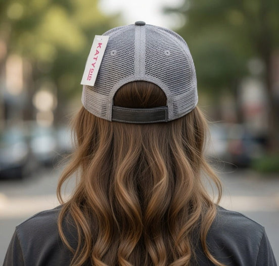 Gray Katydid "Pool Please" trucker hat with mesh back and curved brim, featuring bold text design.