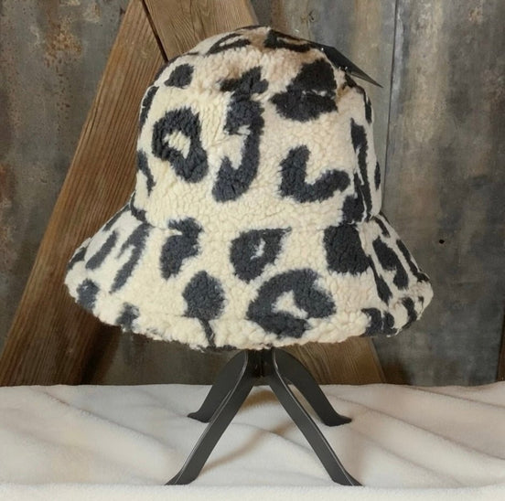 Beige and black leopard print bucket hat from La Plaza Mall, featuring a stylish wide brim and bold animal pattern.