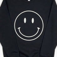 Oat Collective happy face sweatshirt featuring a colorful smiling face graphic on a cozy casual top.