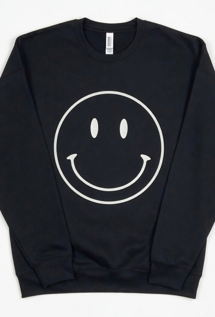 Oat Collective happy face sweatshirt featuring a colorful smiling face graphic on a cozy casual top.