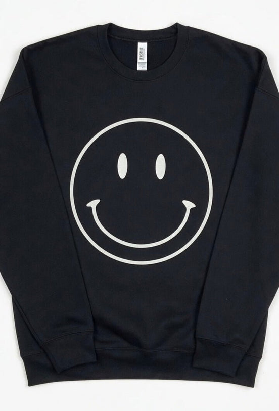 Oat Collective happy face sweatshirt featuring a colorful smiling face graphic on a cozy casual top.