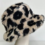 Leopard Sherpa Bucket Hat by Pink Irene Wholesale featuring a soft, cozy sherpa lining and stylish leopard print design.