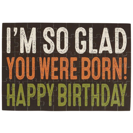 I'm So Glad Puzzle Card by Questionables featuring a colorful, illustrated design with uplifting message and detailed puzzle elements.