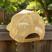Questionables Kinda Shady Trucker Hat with mesh back and curved brim, featuring bold embroidered design on front panel.