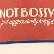 Questionables Not Bossy Trucker Hat featuring a classic mesh design and adjustable strap, perfect for casual outdoor wear.