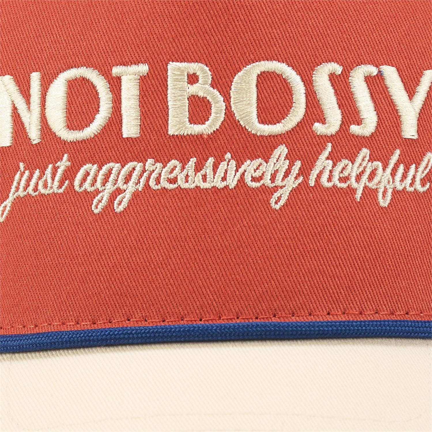 Questionables Not Bossy Trucker Hat featuring a classic mesh design and adjustable strap, perfect for casual outdoor wear.