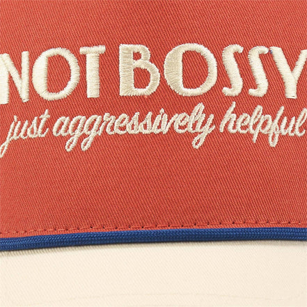 Questionables Not Bossy Trucker Hat featuring a classic mesh design and adjustable strap, perfect for casual outdoor wear.