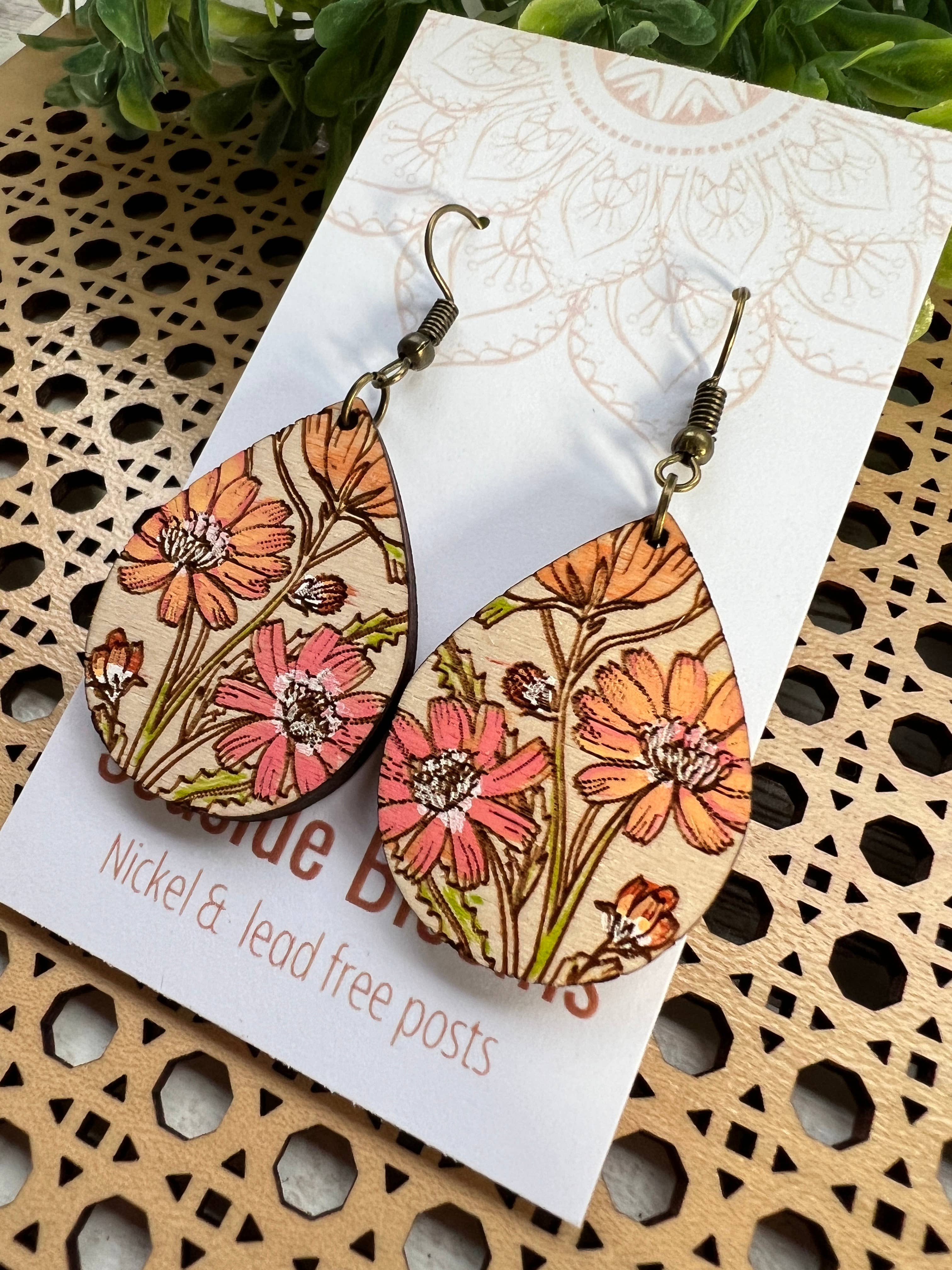 Hand-painted Boho Daisy Wood Earrings by Seasideblooms, lightweight earrings with floral design and natural wood texture.