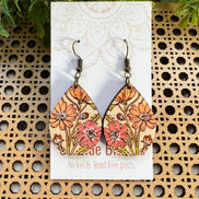 Hand-painted boho Daisy wood earrings by Seasideblooms, lightweight with floral design, hanging from silver hooks.