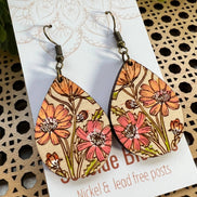 Hand-painted lightweight wooden earrings featuring boho daisy design by Seasideblooms