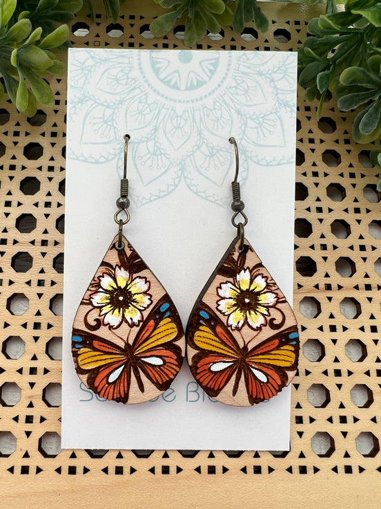 Hand-painted butterfly maple wood earrings by Seasideblooms, lightweight jewelry with colorful butterfly design.