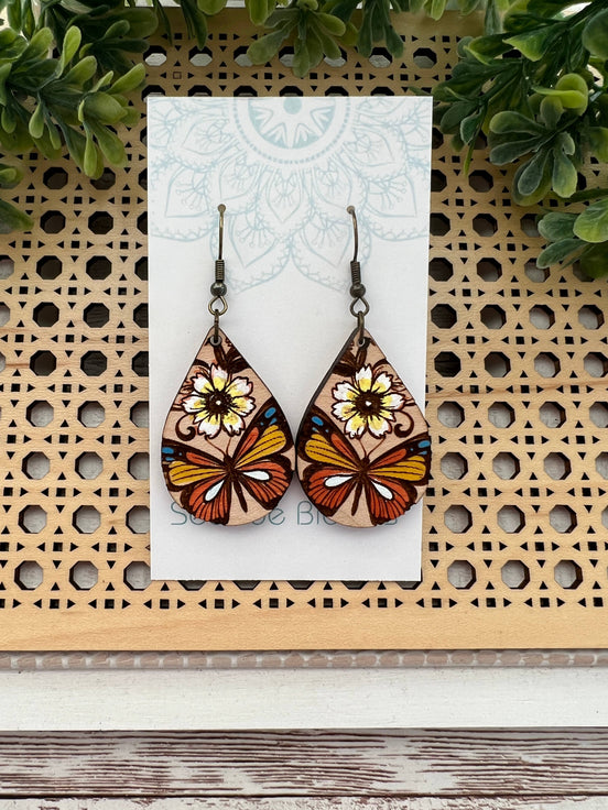 Hand-painted butterfly maple wood earrings by Seasideblooms, lightweight jewelry with colorful butterfly design.