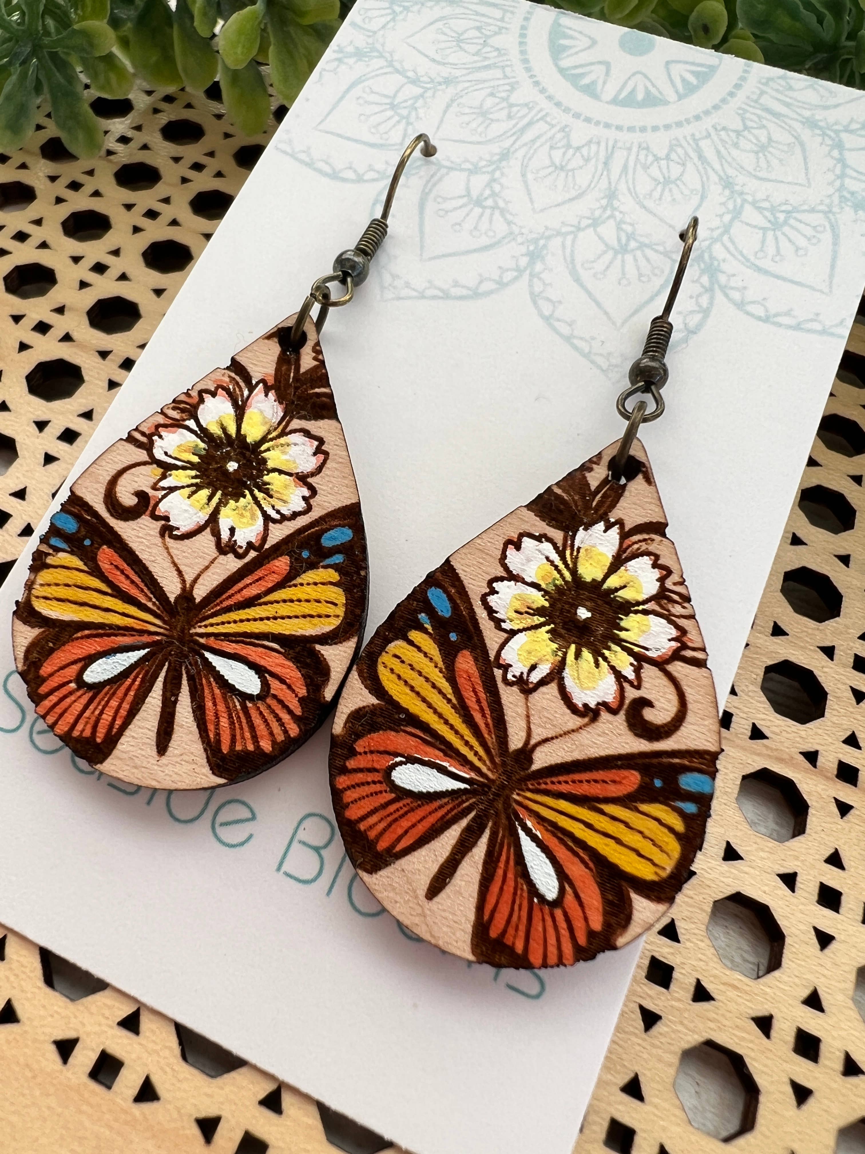 Hand-painted butterfly maple wood earrings by Seasideblooms, lightweight jewelry with colorful butterfly design.