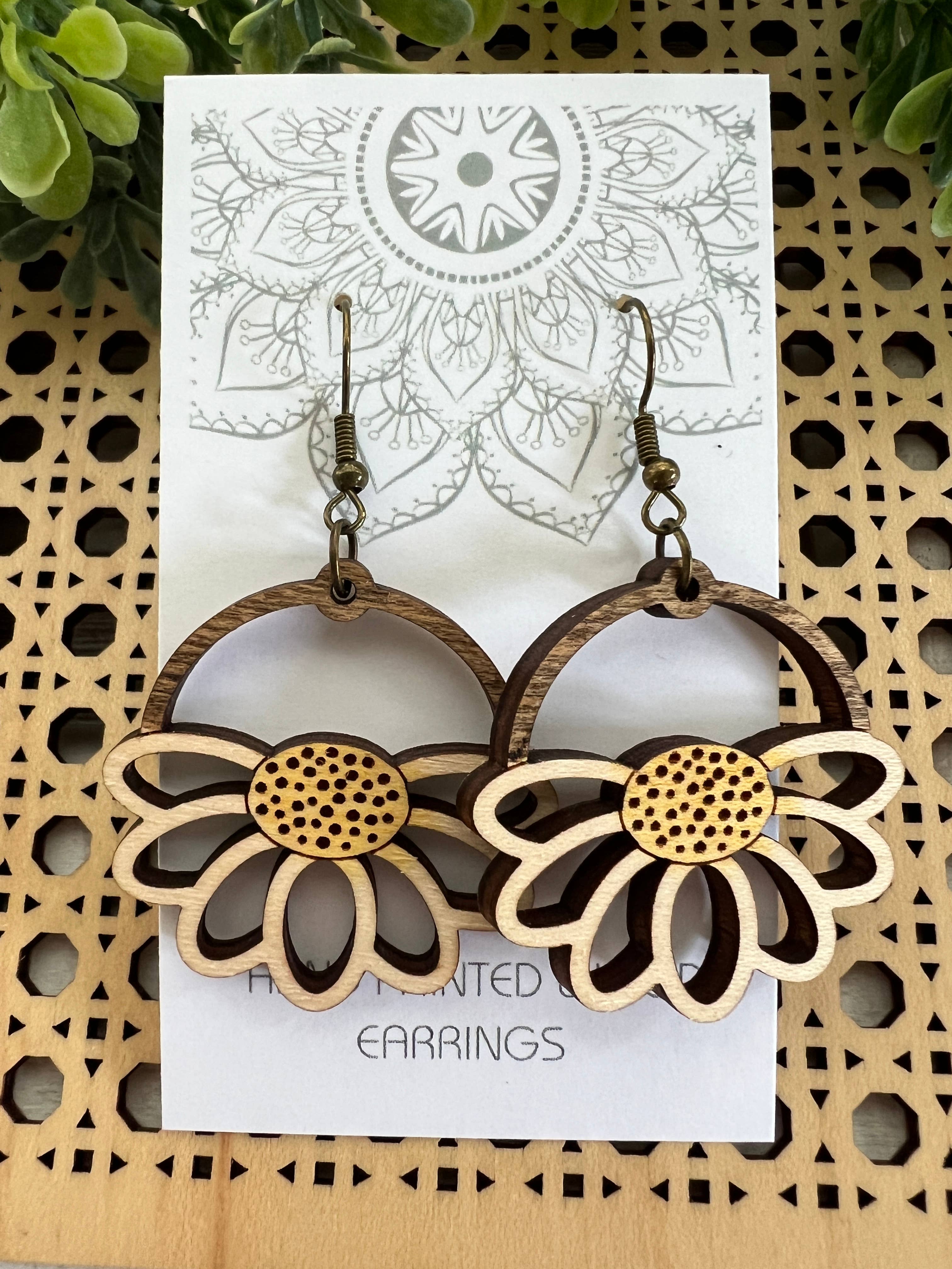 Lightweight Daisy Wood Earrings by Seasideblooms, hand-painted maple wood with floral design, hanging from silver hooks.