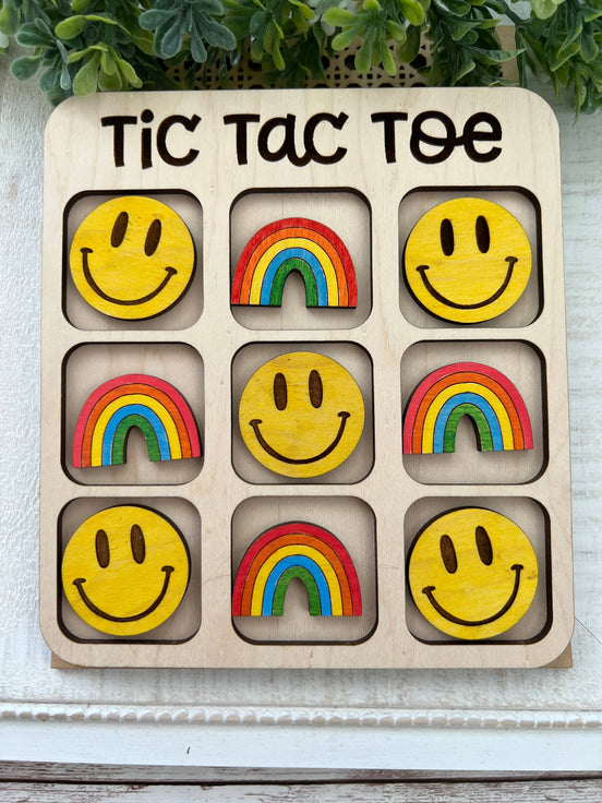 Seasideblooms maple wood tic tac toe board with hand-painted game pieces on a natural wooden surface.