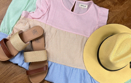 Multi-colored striped sundress by Shopin La, featuring a lightweight summer dress with vibrant horizontal stripes and a sleeveless design.